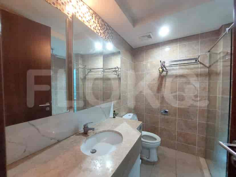 Bathroom with a white sink, a toilet, and a large mirror.