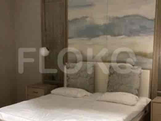A cozy bedroom featuring a comfortable bed and artwork.