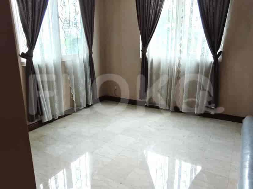 Empty room with windows and marble flooring.