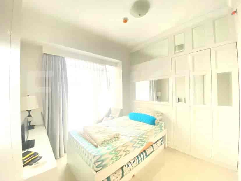 A well-lit bedroom featuring a single bed and a large wardrobe.