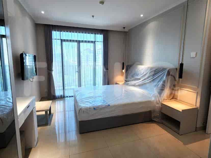 Bedroom with a bed, nightstands, and large windows.