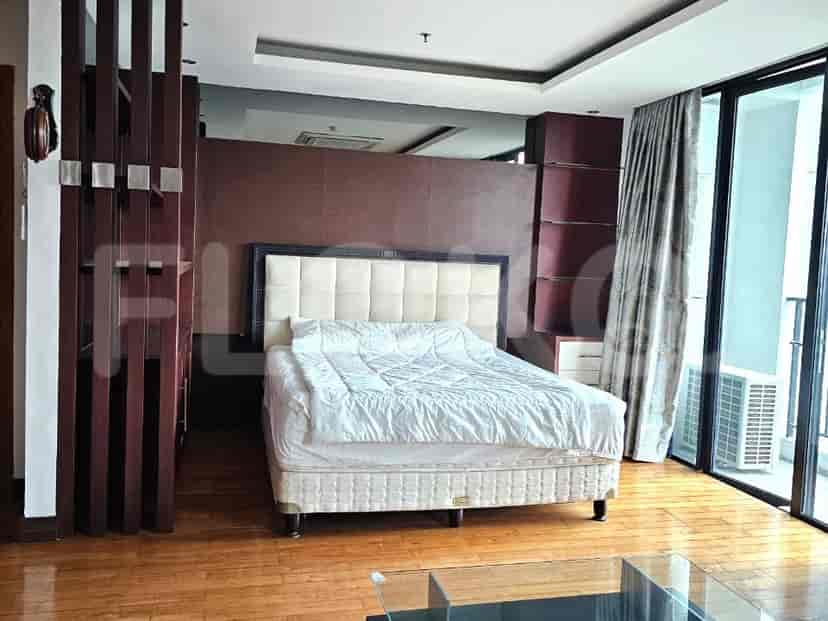 Spacious bedroom with wooden floors, large bed, and modern design.