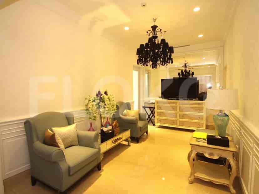 A formal living room with seating, TV, and decorative elements.