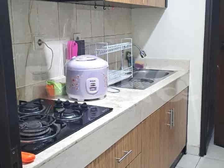 Dapur ringkas dengan kompor, wastafel, dan penanak nasi.