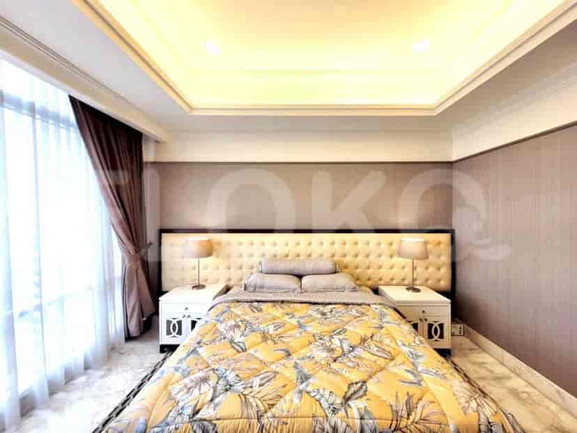 A luxurious bedroom with a large bed and stylish bedside tables.
