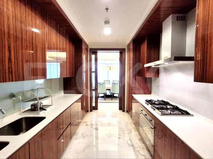 A modern kitchen with wooden cabinets and stainless steel appliances.