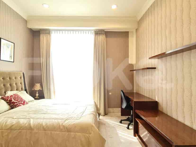 A bedroom with a bed, desk, and contemporary decor.