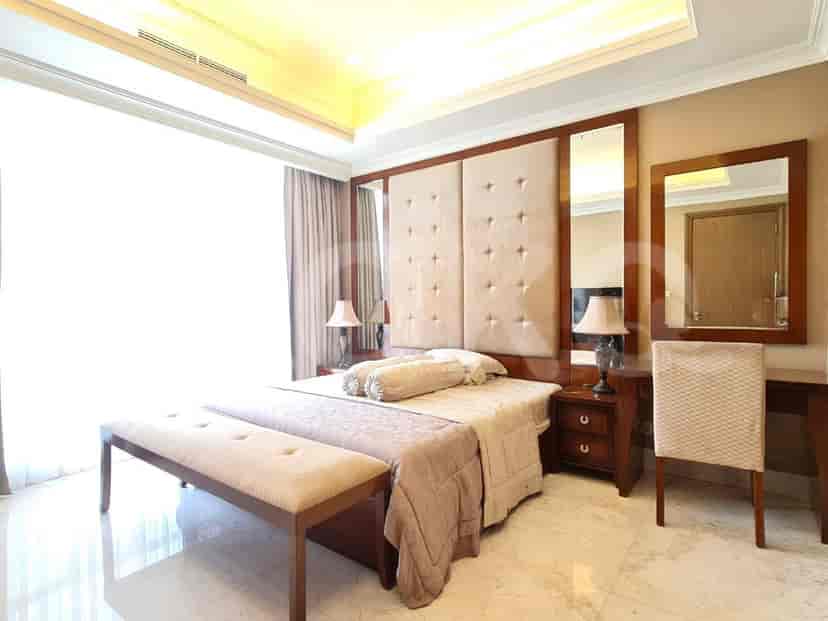 A master bedroom featuring a bed, seating, and a dressing table.