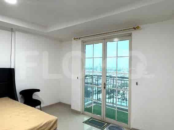 The bedroom featuring a bed and a balcony view.