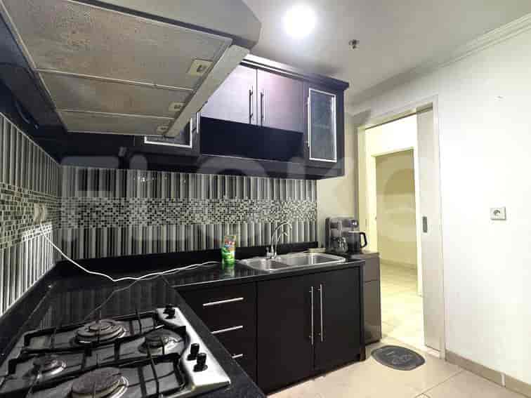 The kitchen has a dark cabinet and kitchenware.