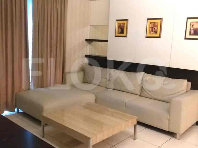 Living room with a sectional sofa, coffee table, and artwork.