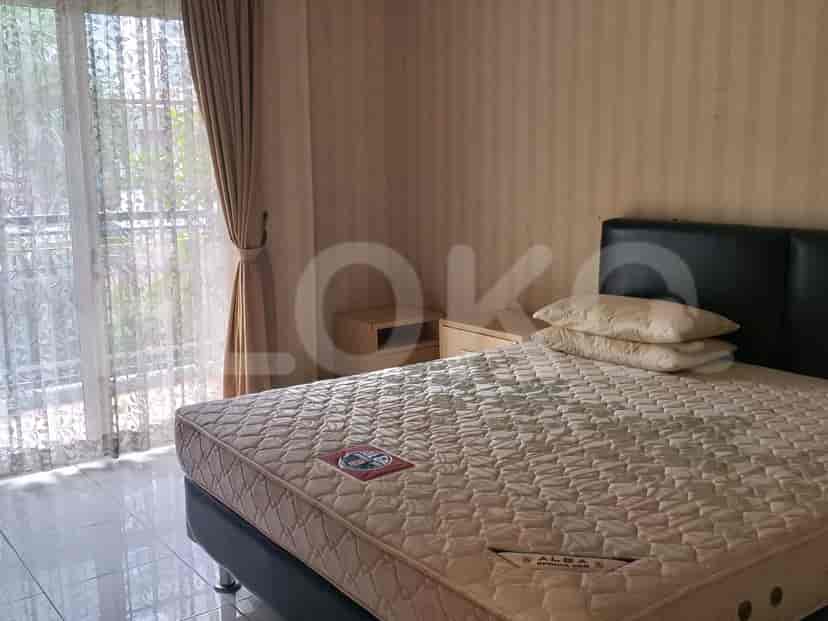 Master bedroom with a double bed, nightstand, and curtains.