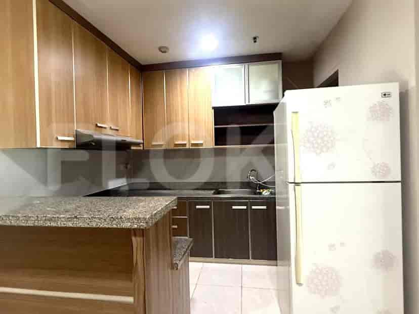 A well-equipped kitchen with wooden cabinets and a white refrigerator.