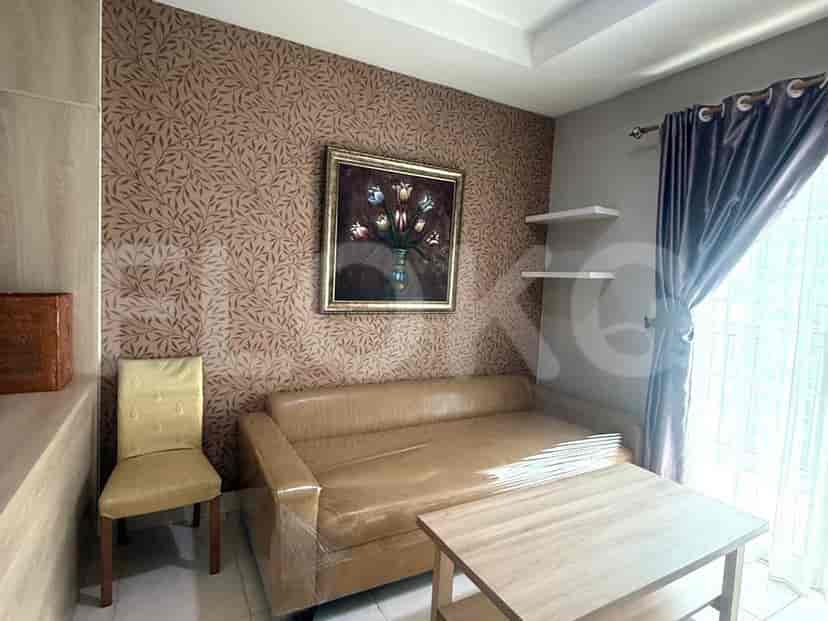 Living room featuring a sofa, small table, and a chair.