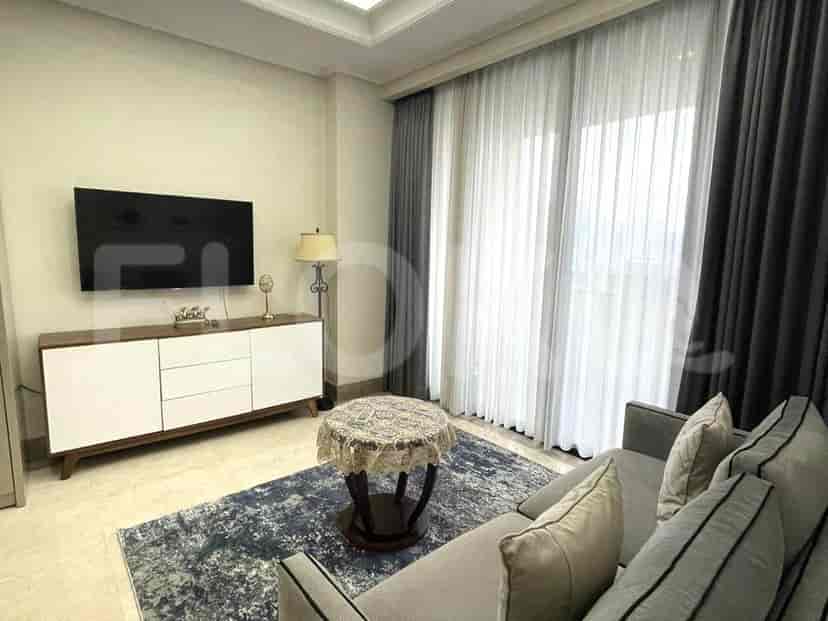 A modern living room with a TV, sofa, and a coffee table.