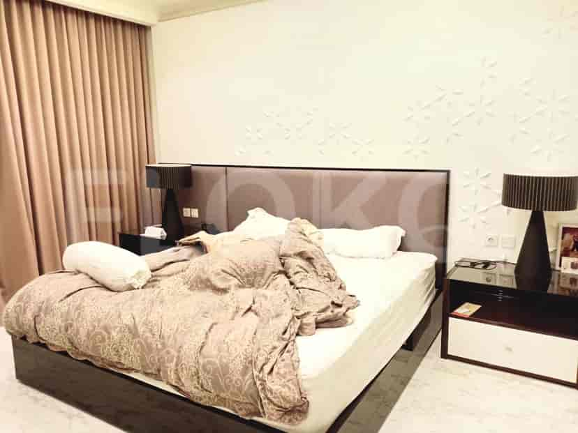 A bedroom with a large bed and decorative wall.