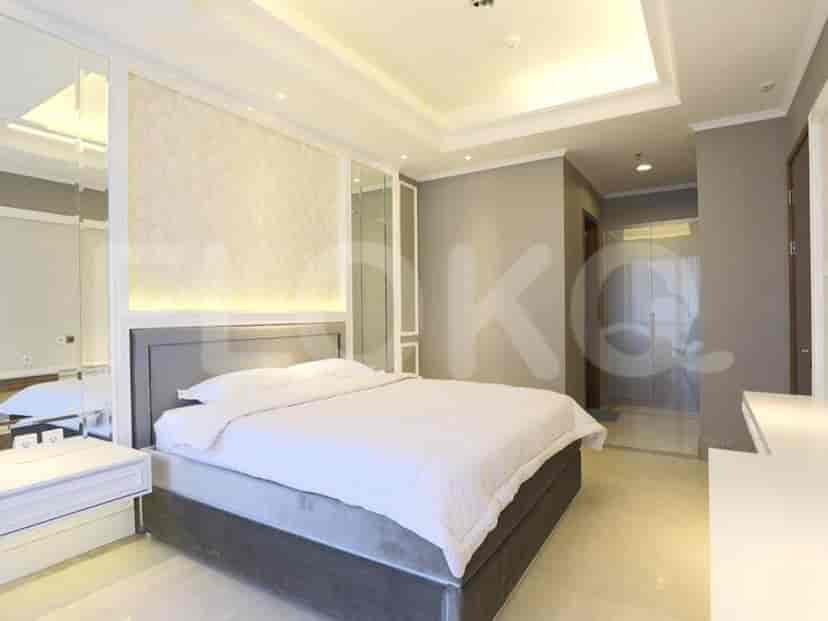 Bedroom with a bed, a headboard, and a side table.