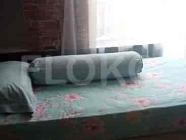 Another view of a bedroom, featuring a bed and bolster pillow.