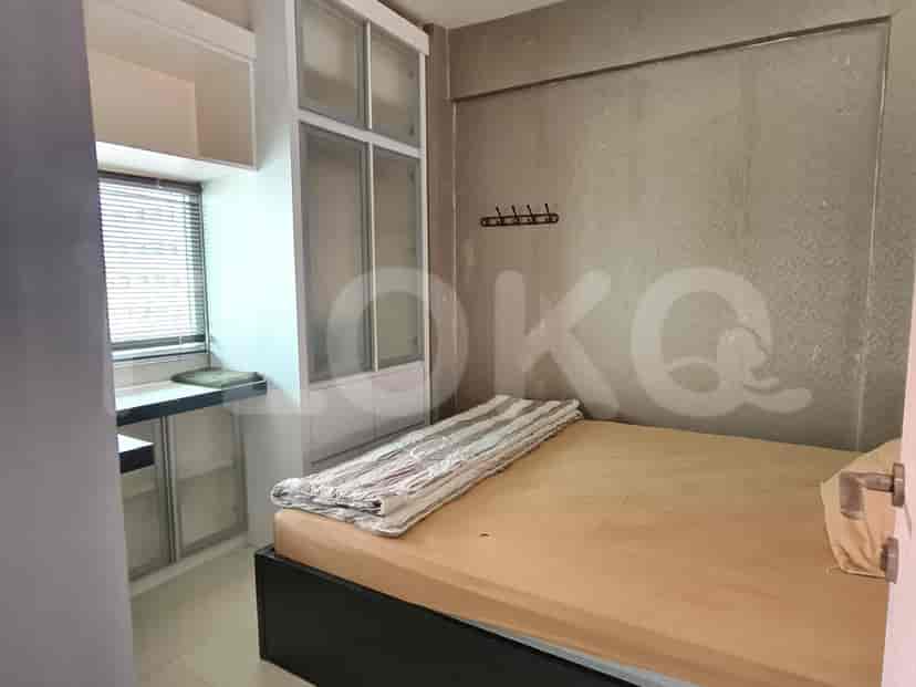 Bedroom with bed, wardrobe, and desk.