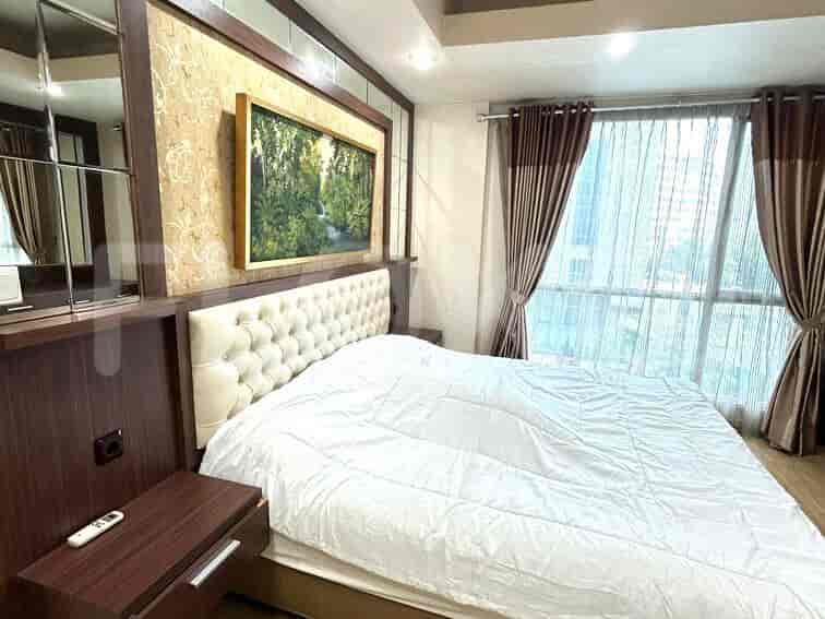A luxurious master bedroom with a king-sized bed and large windows.
