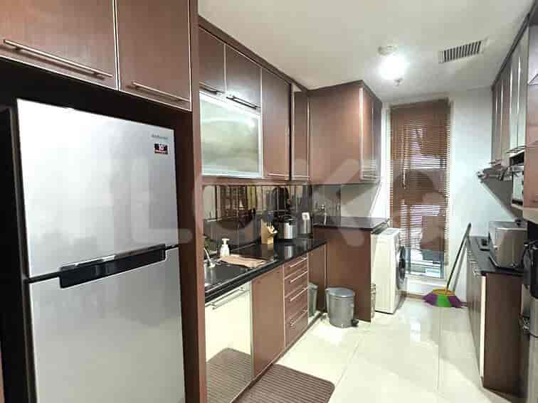 A modern kitchen with stainless steel appliances and dark cabinets.