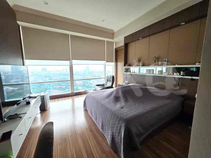 Modern bedroom with a king-sized bed and large windows.