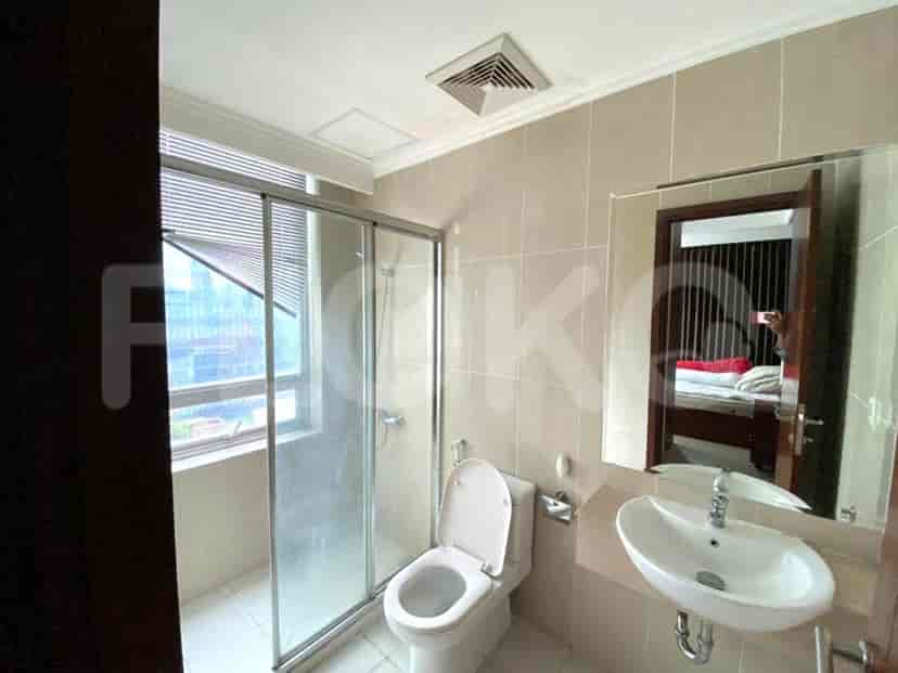 Modern bathroom with a glass-enclosed shower and a white toilet.