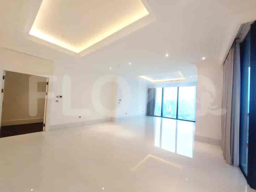 Bright and spacious living room with white walls, glossy floor, and large windows.
