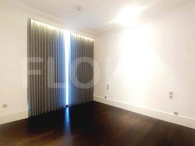 Bedroom with curtains, dark wood flooring, and white walls.