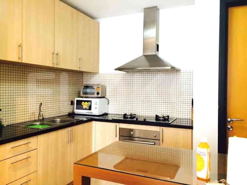 A modern kitchen with wooden cabinets and stainless steel appliances.