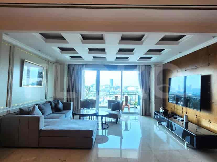 Luxurious living room with a modern design, featuring an L-shaped sofa, large windows, and a city view.