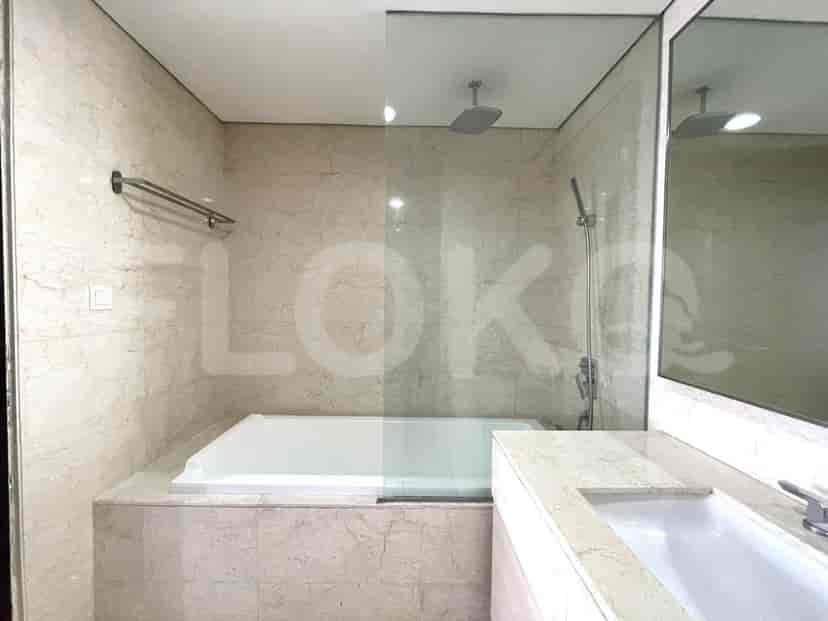A modern bathroom featuring a bathtub and a marble theme.