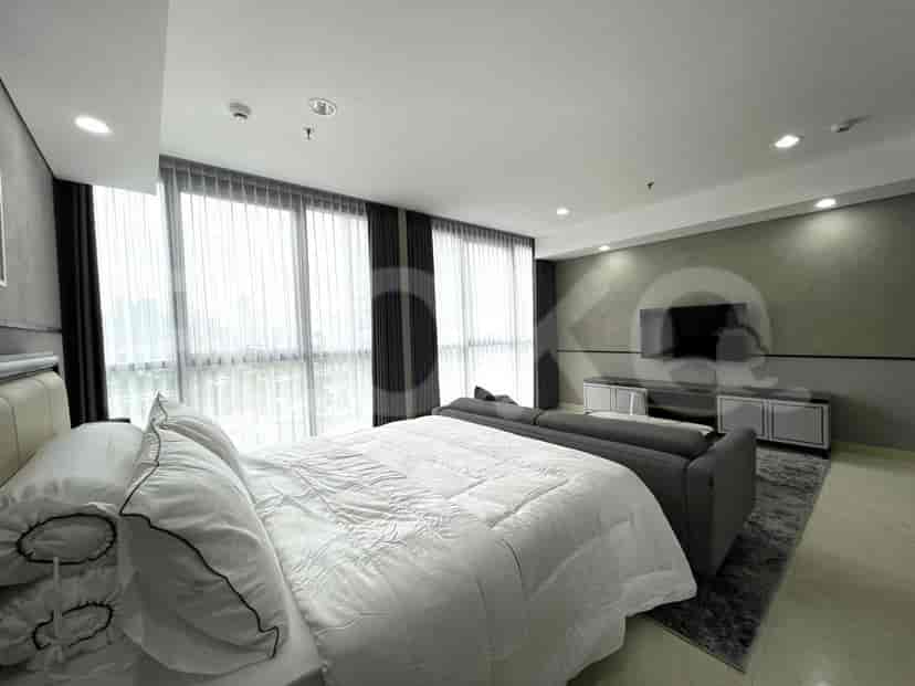 Bedroom space including a bed, sofa, and large window, with a view.