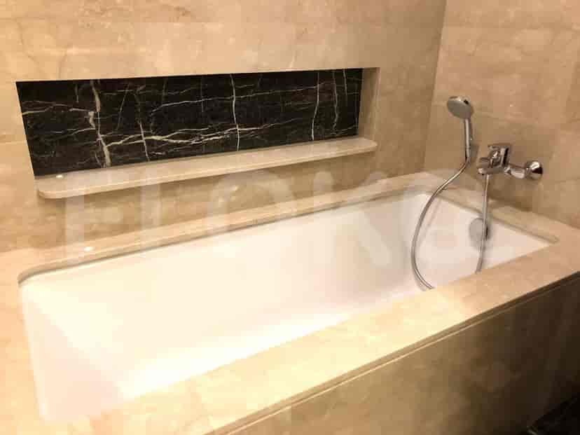 A luxurious bathroom with a bathtub and marble detailing.