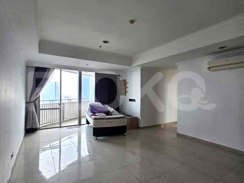 A bedroom with a bed, balcony access, and neutral tones.