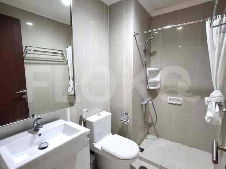 A bathroom with a shower, sink, and toilet.