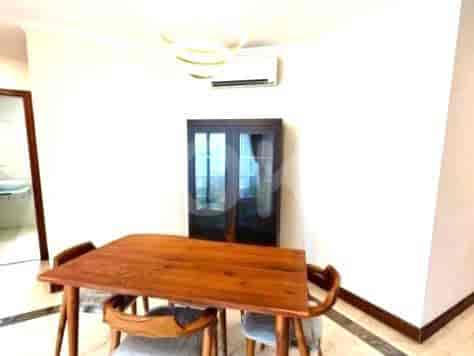 Dining area with a table, chairs, and cabinet.