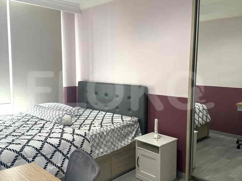 Bedroom with bed and mirror closet.