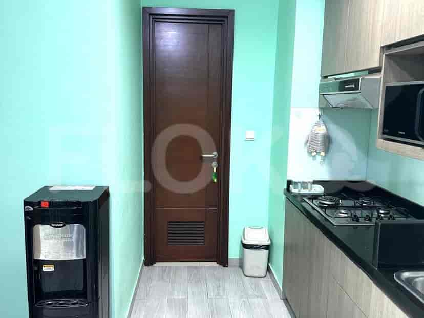 Kitchen with cabinets and a water dispenser.