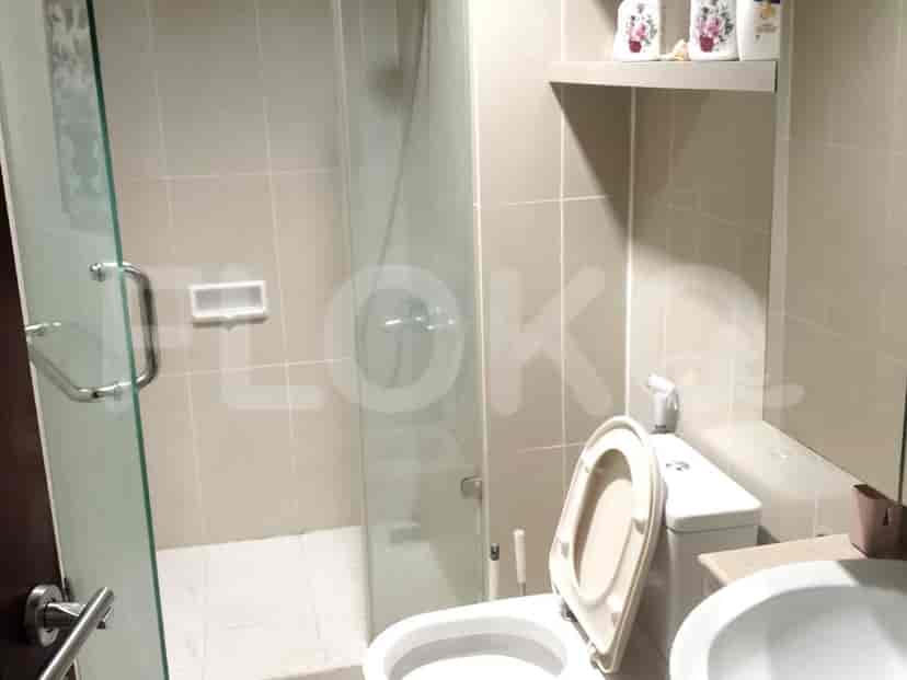 A well-designed bathroom with a glass shower door and white tiling.