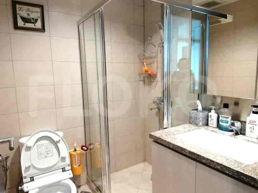 A bathroom with a shower, a toilet, and a sink.