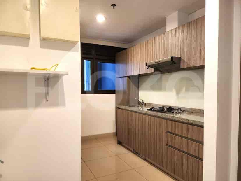 A modern kitchen with wooden cabinets and a gas stove.
