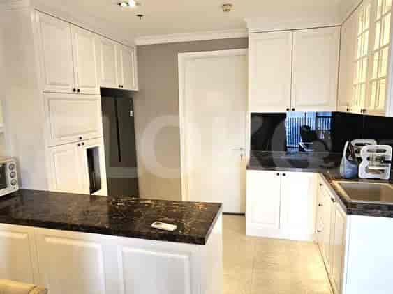 Modern kitchen with white cabinets, a dark countertop, and an open design.
