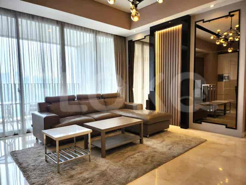 A modern living room with a brown L-shaped sofa, coffee tables, and large windows.