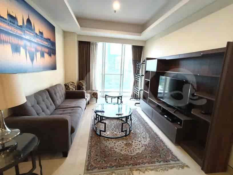 A modern living room featuring a comfortable sofa, a wall-mounted TV, and a city view.
