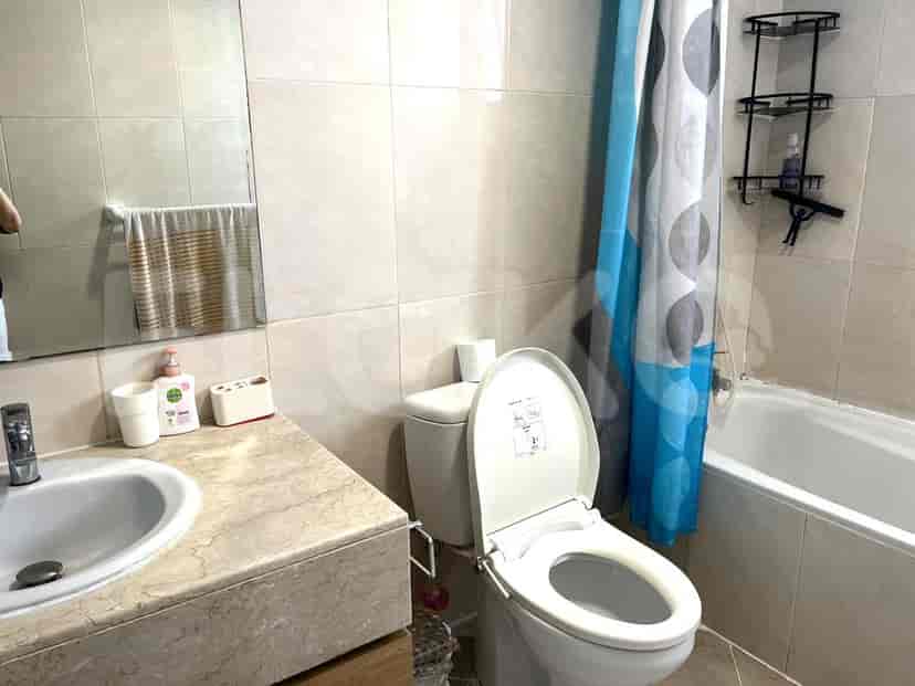 Bathroom with a toilet, sink, and bathtub.