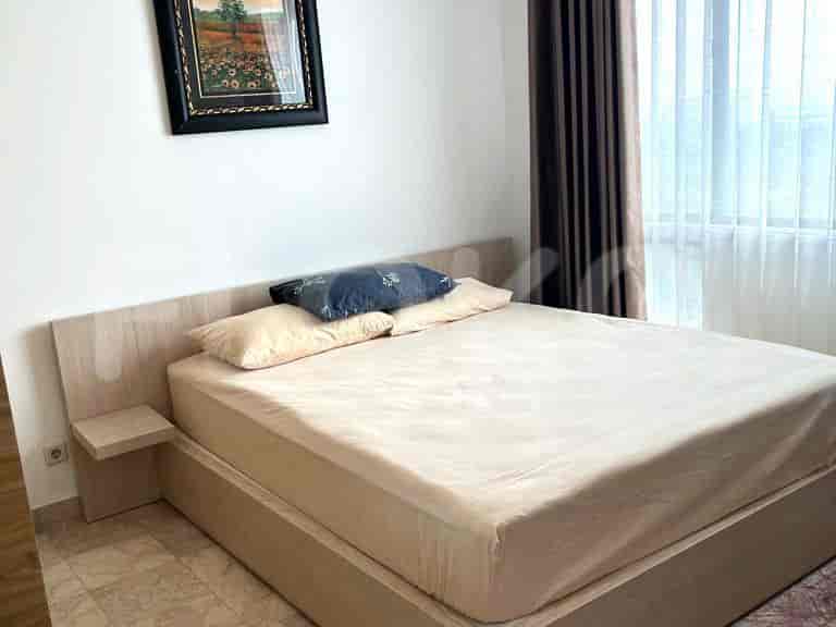 Bedroom with a bed, a nightstand, and curtains.