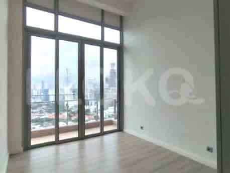 Bedroom with large windows and city views.