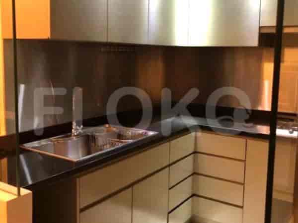 A modern kitchen with stainless steel accents and black countertops.