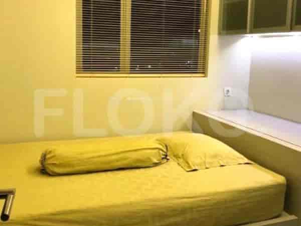 A small bedroom with a single bed and a simple design.